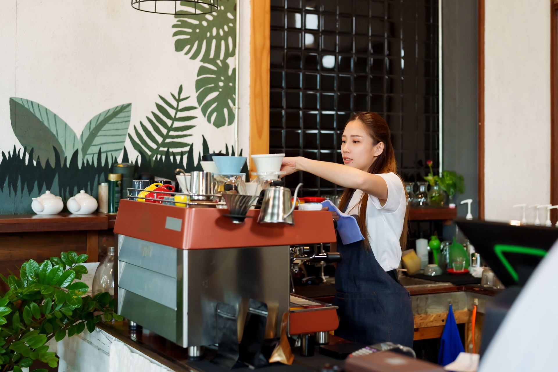Asian beautiful woman Wiping down cup of coffee behind bar counter in cafe And prepare to open cafe in morning of every day. to be ready to accept customers. coffee shop owner Family small business.